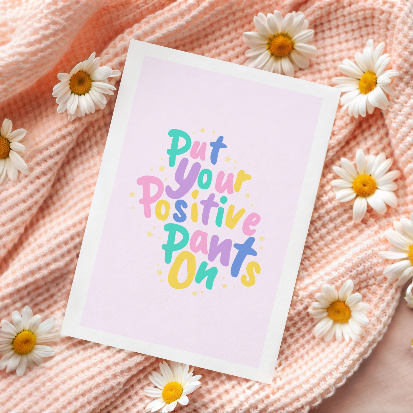 A colourful card that reads 'put your positive pants on'.