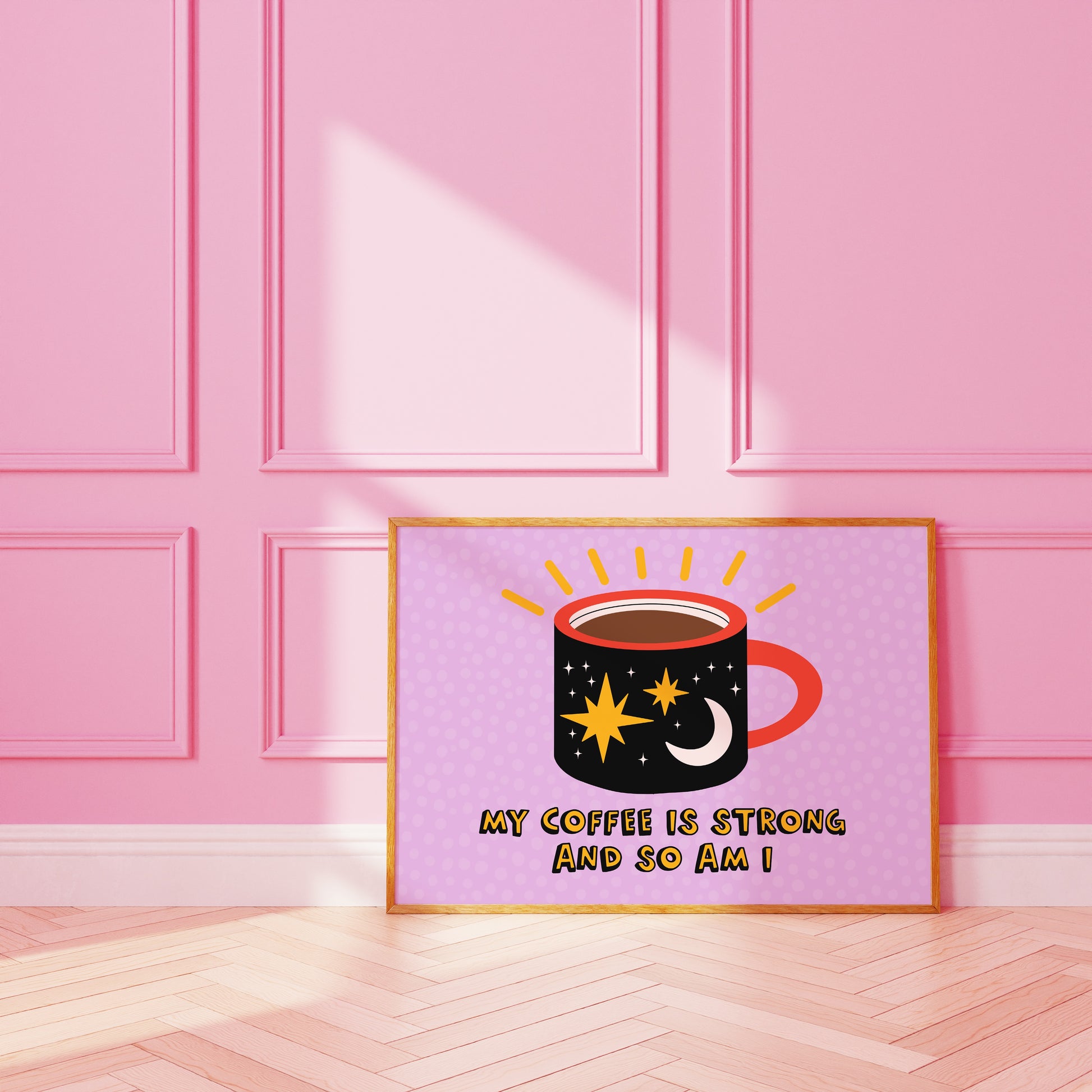 A framed print with a vibrant illustration of a coffee mug, with stars and a sun motif, and the text 'MY COFFEE IS STRONG AND SO AM I!' on a purple background.