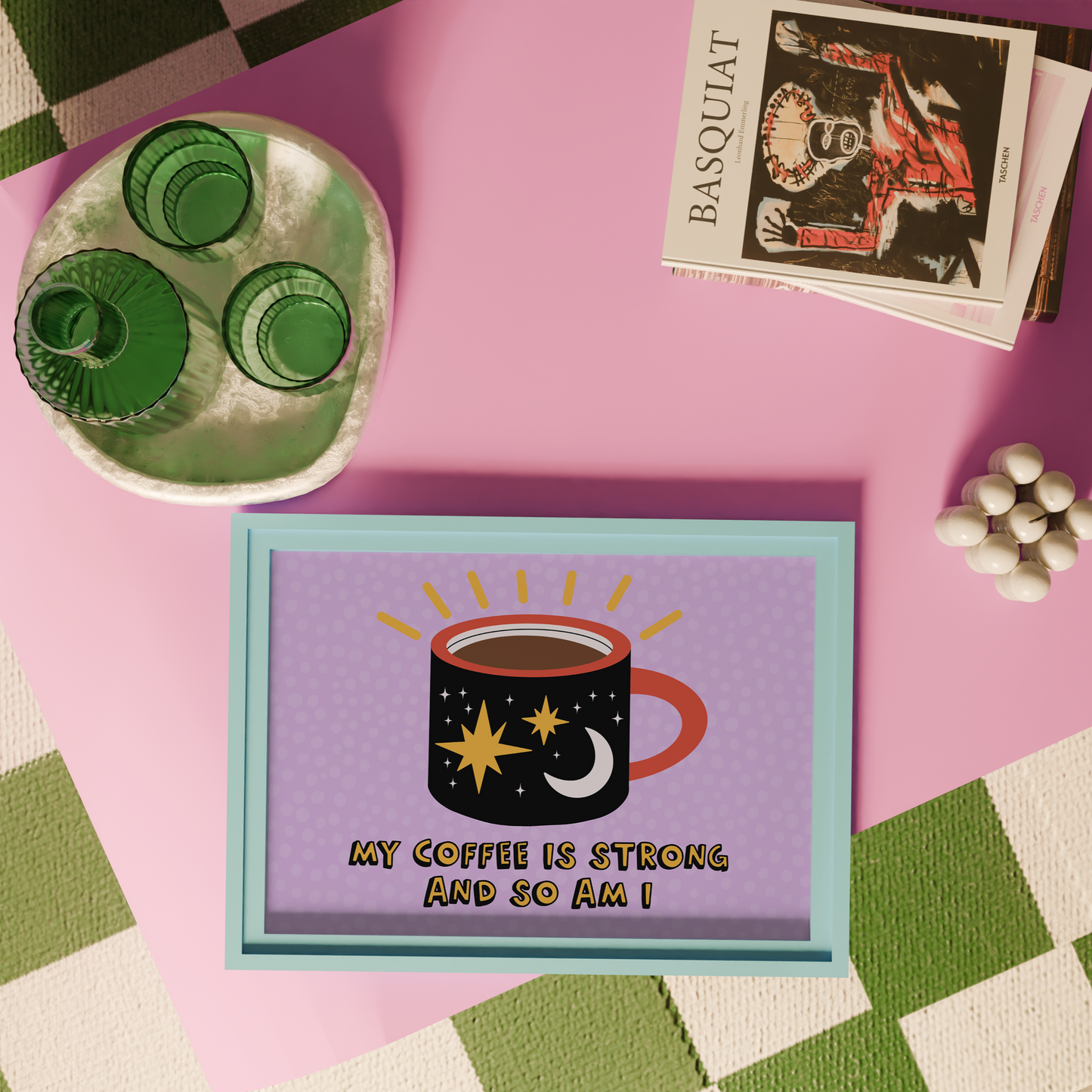A framed print with a vibrant illustration of a coffee mug, with stars and a sun motif, and the text 'MY COFFEE IS STRONG AND SO AM I!' on a purple background.