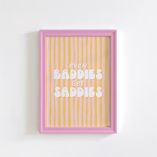 A funny quote print saying Even Baddies Get Baddies Print on a yellow and pink striped background.