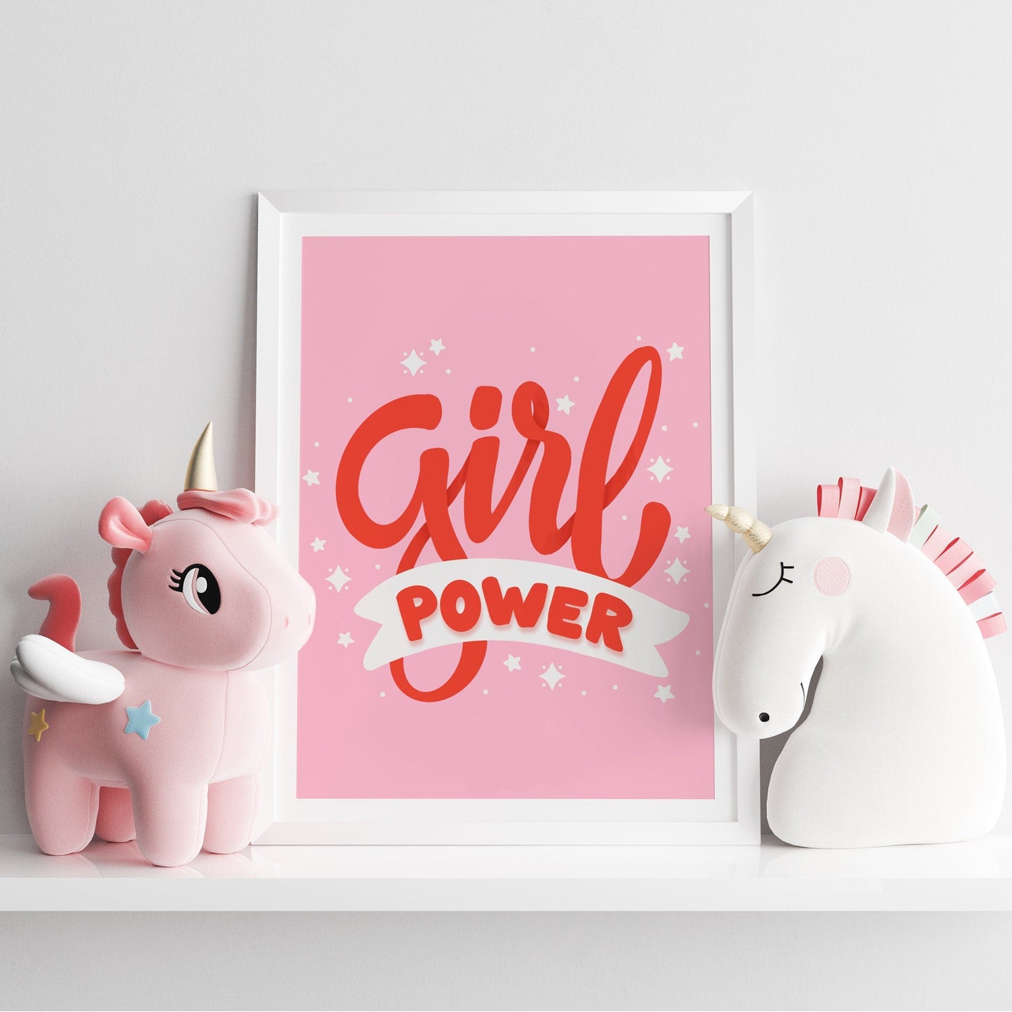 A quote print with the words 'Girl Power' in red text on a pink background.