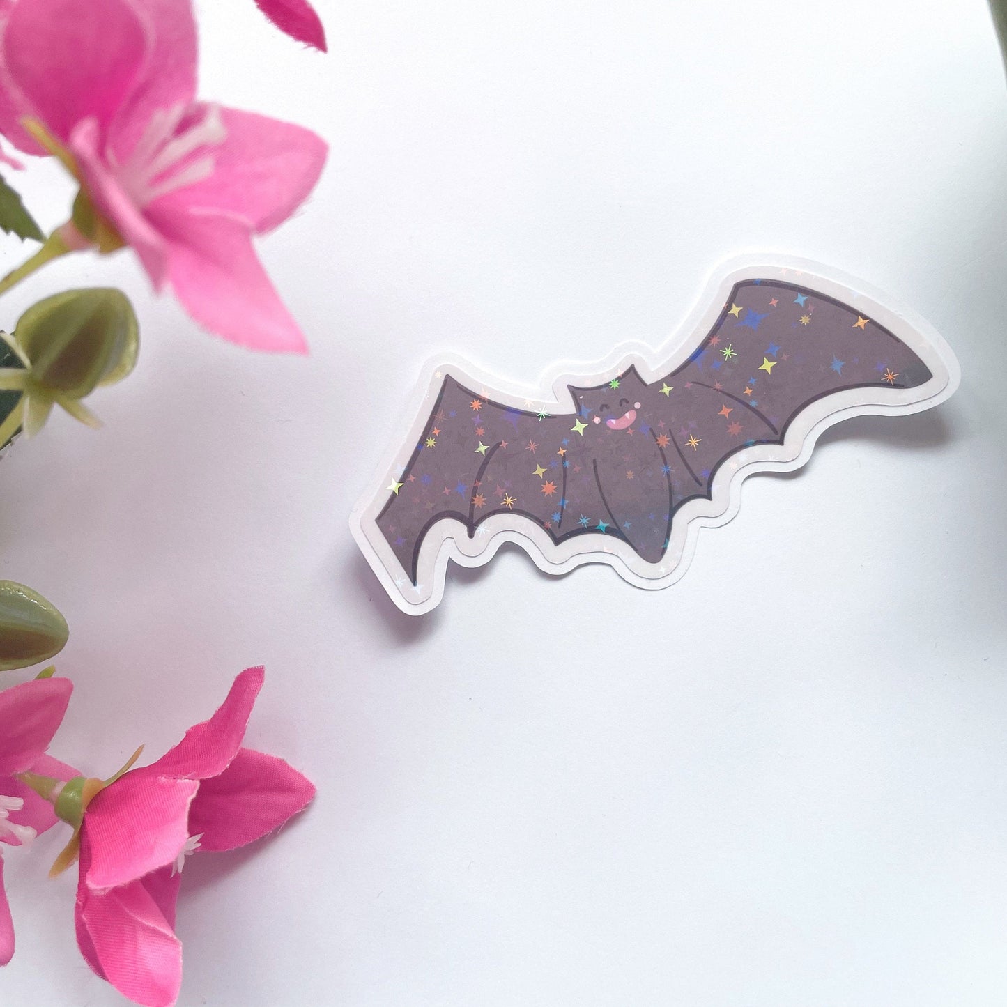 An image of a bat sticker, with a holographic finish and an easy-peel lip to detach the sticker from its backing easily.