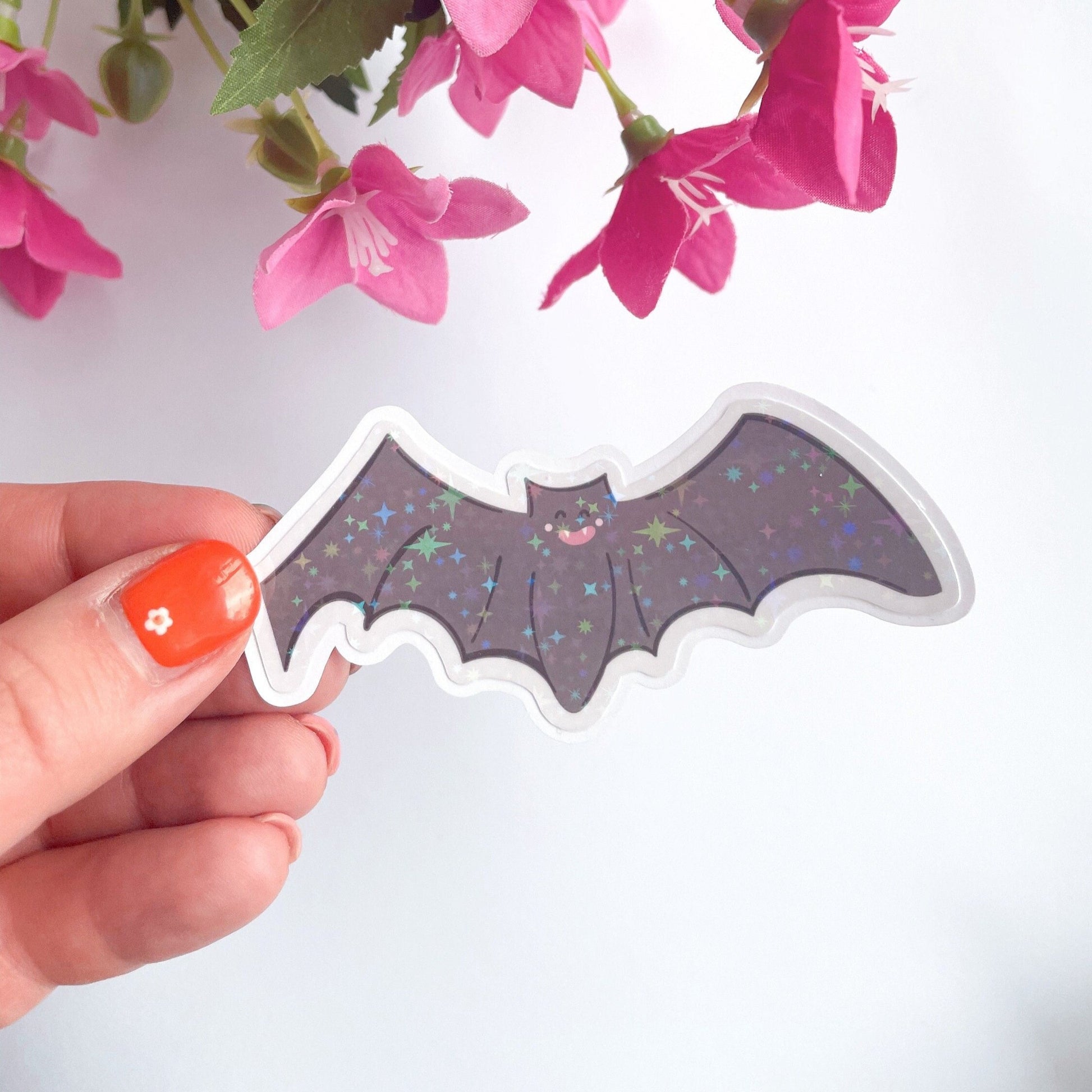 An image of a bat sticker, with a holographic finish and an easy-peel lip to detach the sticker from its backing easily.
