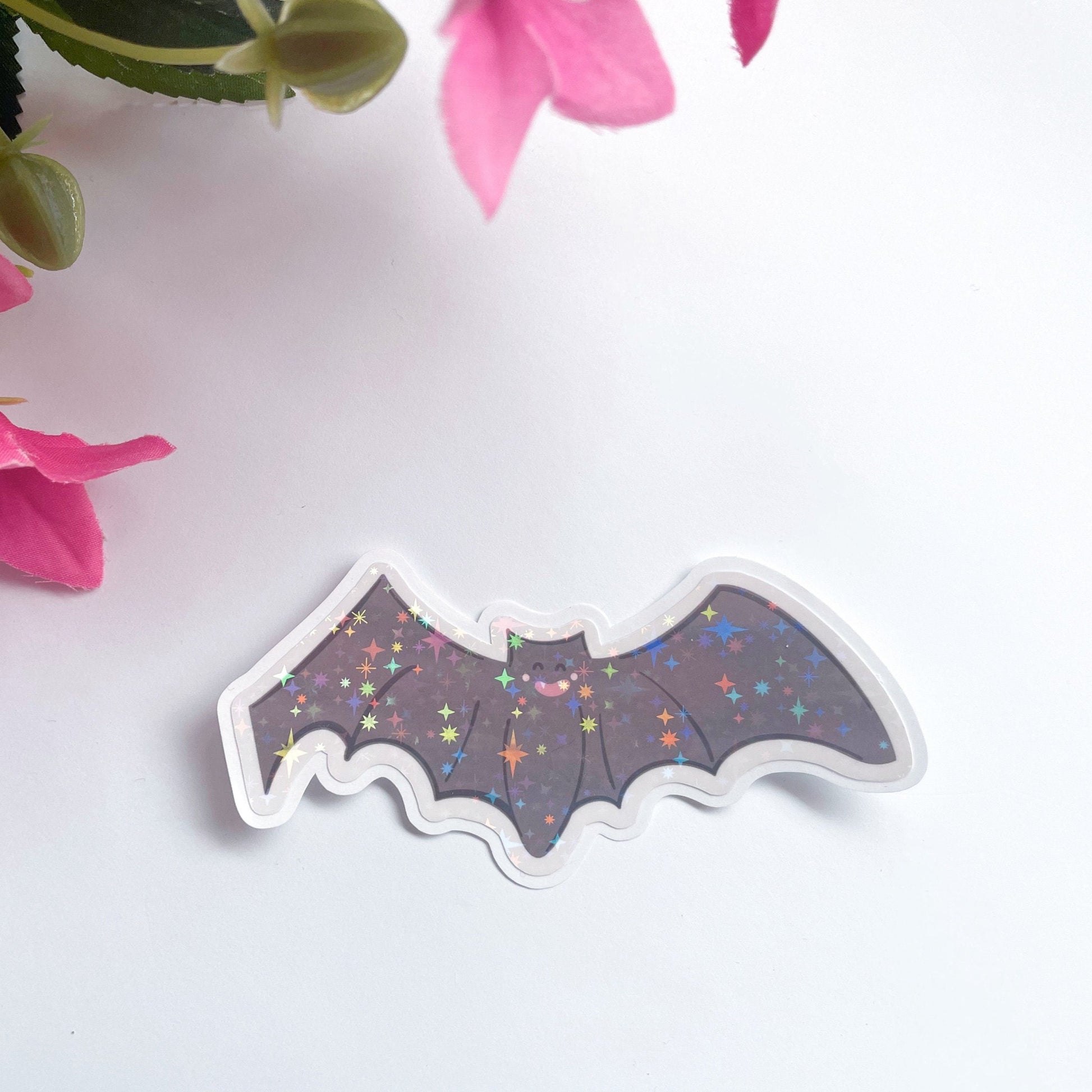 An image of a bat sticker, with a holographic finish and an easy-peel lip to detach the sticker from its backing easily.