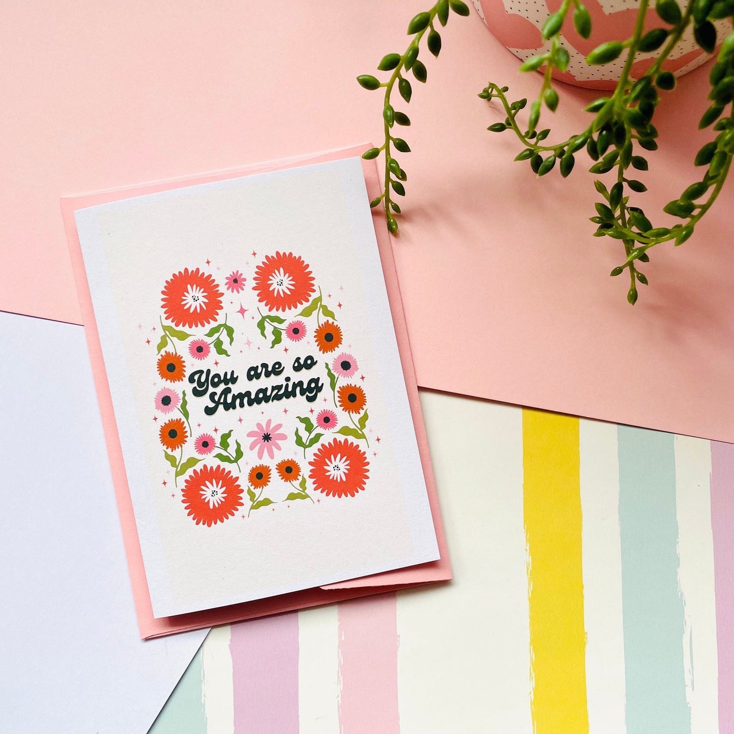 A card with a floral border, and text reading you are so amazing n the centre.